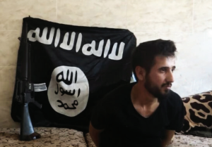 A man held by ISIS. (Dabiq)