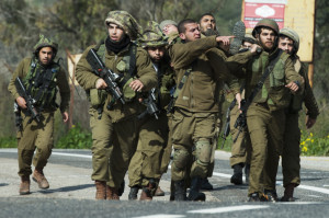 Israeli soldiers seen being treated after an IDF patrol came under anti-tank fire from Hezbollah operatives in the northern Mount Dov region along the Israeli border with Lebanon on January 28, 2015. (Flash 90)