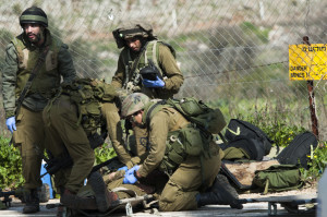 Israeli soldiers giving medical care after an IDF patrol came under anti-tank fire from Hezbollah operatives. (Flash90)