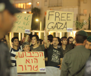 Israeli left wing activists holding placards during a demonstration. (Photo by Yossi Aloni/Flash90)