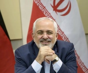 Iranian Foreign Minister Zarif smiles as he waits for the start of a negotiations meeting. (REUTERS/Brendan Smialowski/Pool)