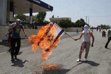 Palestinians burn flag