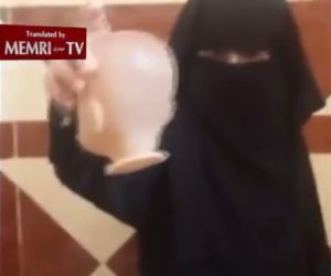 ISIS girl beheads doll