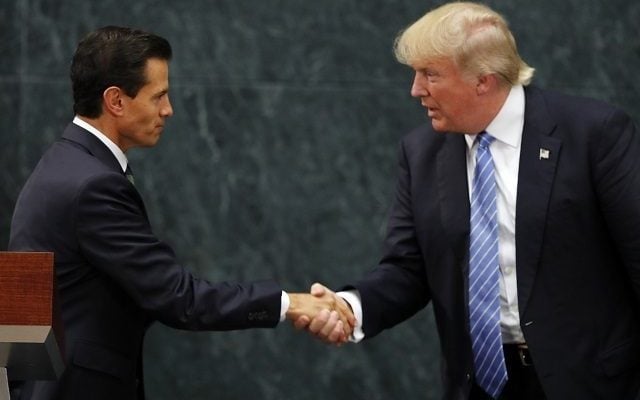 In Mexico, Trump defends building wall along border