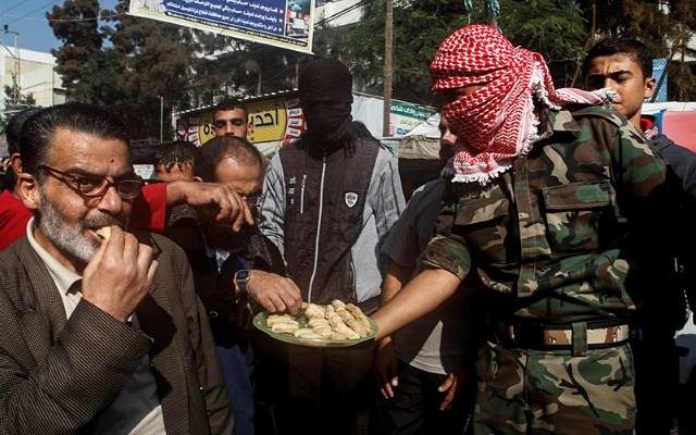 Palestinians hand out candies to celebrate murder of Israelis