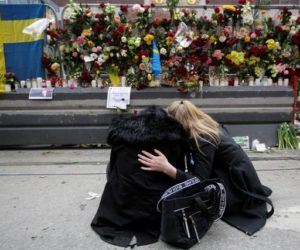 Women mourn after an attack in Sweden. (AP/Markus Schreiber)