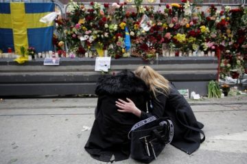 Women mourn after an attack in Sweden. (AP/Markus Schreiber)