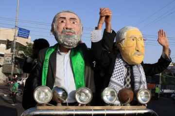 Palestinians dressed as Fatah's Mahmoud Abbas (L) and Hamas' Ismail Haniyeh. (Wissam Nassar/Flash90)