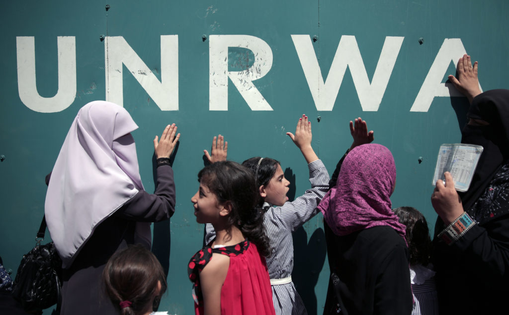 Palestinians at UNRWA HQ. (AP Photo/Khalil Hamra)