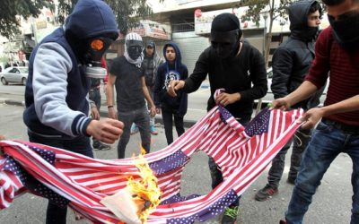 Palestinian protestors burn US flags