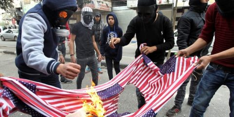 Palestinian protestors burn US flags