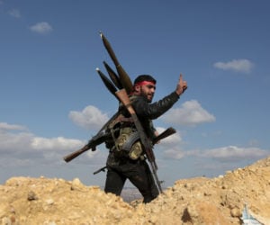 A Syrian fighter on the hill separating Kurdish-held Afrin from Turkey-controlled Azaz. (AP Photo)