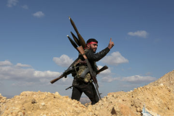A Syrian fighter on the hill separating Kurdish-held Afrin from Turkey-controlled Azaz. (AP Photo)
