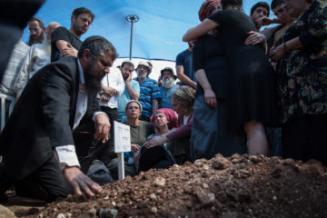 Family and friends attend the funeral of Adiel Kolman. (Hadas Parush/Flash90)