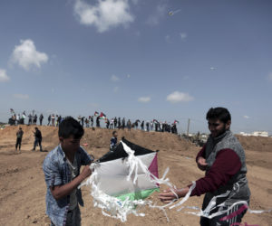 Palestinians fly kites near the Gaza border with Israel. (AP Photo/Khalil Hamra)