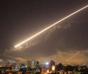 Damascus skies erupt with surface to air missile fire as the U.S. launches an attack on Syria. (AP Photo/Hassan Ammar)