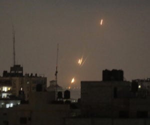 Flames of rockets fired by Palestinian Islamists are seen over Gaza Strip. (AP Photo/Hatem Moussa)