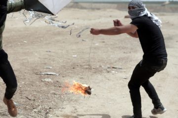 Palestinian rioters fly an arson terror kite at the Gaza border. (AP Photo/ Khalil Hamra)