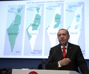 Turkey's President Recep Tayyip Erdogan with maps of Israel. (Kayhan Ozer/Pool Photo via AP)