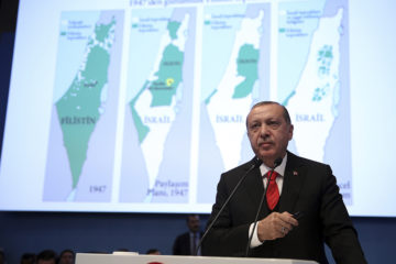 Turkey's President Recep Tayyip Erdogan with maps of Israel. (Kayhan Ozer/Pool Photo via AP)