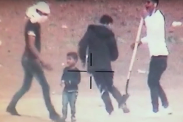 Palestinian terrorists use a child as a human shield in Gaza. (screenshot)