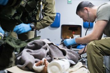 An Israeli army medic cares for an injured Syrian. (Israel Defense Forces)
