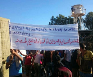 Syrians protest alongside the border asking Israel for protection from President Bashar al-Assad. (TPS)