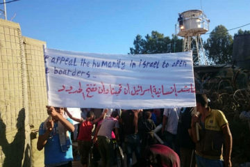 Syrians protest alongside the border asking Israel for protection from President Bashar al-Assad. (TPS)