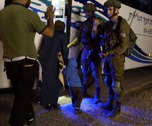 White Helmets and families with IDF soldiers, boarding a bus to Jordan. (Israeli Defence Forces via AP)