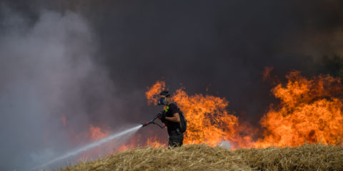 Israeli firefighters battle a previous fire caused by Palestinian terrorists' kites. (Yonatan Sindel/Flash90)