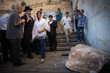 Chief Rabbi David Lau with the director-general of the Israel Antiquities Authority, Israel Hasson, and he boulder that fell. (Yonatan Sindel/Flash90)