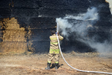 Firefighters battle a fire caused by a Palestinian arson kite. (Gili Yaari/FLASH90)