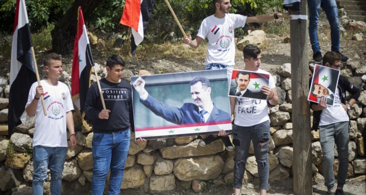 Golan Druze gather at border, chant loyalty to Syria’s Assad
