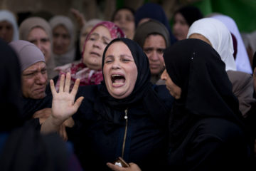 Relatives of Aisha Rabi, 48, mourn at the family home. (AP Photo/Majdi Mohammed)
