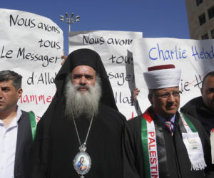 Palestinian Archbishop Atallah Hanna (C) protesting a cartoon of Muhammad published by Charlie Hebdo. (AP Photo/Nasser Shiyoukhi)