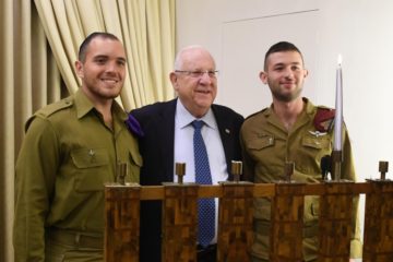 President Rivlin lighting Chanukah candles with ultra-Orthodox soldiers. (Mark Neiman/GPO)