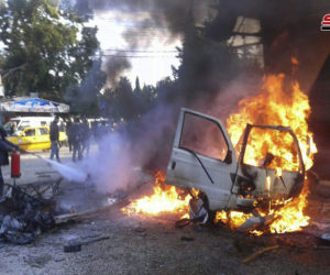 Flames rising from a burned car in Latakia, Syria, Tuesday, Jan. 22, 2019. (SANA via AP)