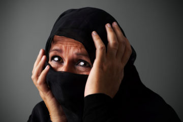 woman in burka in distress