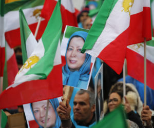 Demonstrators carry posters of Maryam Rajavi