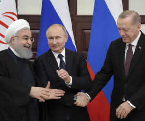 Russian President Vladimir Putin, center, Iranian President Hassan Rouhani, left, and Turkish President Recep Tayyip Erdogan. (Sergei Chirikov/Pool Photo via AP)
