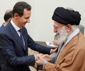 Syrian President Bashar Assad, left, shakes hands with Iranian Supreme Leader Ayatollah Ali Khamenei. (SANA via AP)