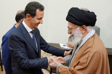 Syrian President Bashar Assad, left, shakes hands with Iranian Supreme Leader Ayatollah Ali Khamenei. (SANA via AP)