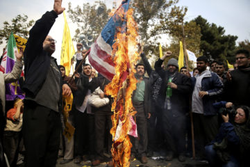 Iranian protesters burn an American flag. (AP Photo/Ebrahim Noroozi)