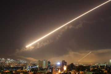 A previous airstrike on Damascus. (AP Photo/Hassan Ammar)