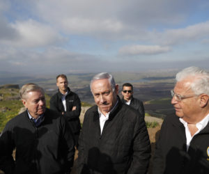 Israeli Prime Minister Benjamin Netanyahu (c), U.S. Senator Lindsey Graham (l), and U.S. Ambassador to Israel David Friedman (r)in the Golan Heights, Monday, March 11, 2019. Graham says he will push for American recognition of Israeli sovereignty over the Golan Heights, a territory it captured from Syria in the 1967 Mideast war. (Ronen Zvulun/Pool via AP)