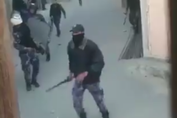 Hamas member beating protesters. (screenshot)