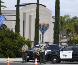 San Diego county sheriff deputies stand in front of the Chabad of Poway. (AP Photo/Denis Poroy)