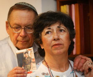 Miriam and Yoni Baumel hold a picture of their son Zachary Baumel, who went missing in 1982. (Flash90)