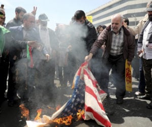 Iranians burn a U.S. flag on May 10, 2019. (AP Photo/Ebrahim Noroozi)