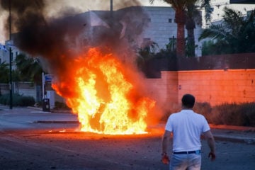 A car bursts into flames after it was hit by a rocket fired from the Gaza Strip in the southern Israeli city of Ashdod. (Flash90)